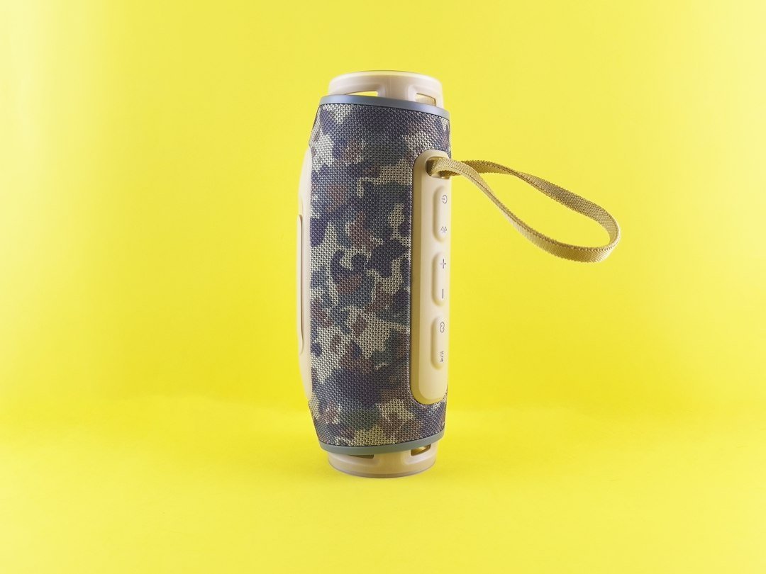 Portable Bluetooth speaker product on a yellow background