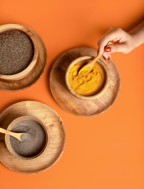 Powdered spice being stirred in a wooden bowl for a herbal powders guide